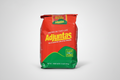 Red and green coffee bag with 'Adjuntas' branding on a white background